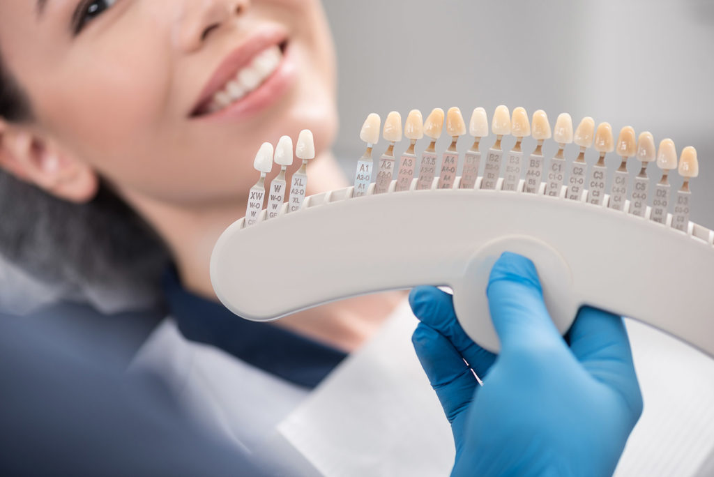 Odontologist,Arms,Showing,Teeth,Implants,To,Patient